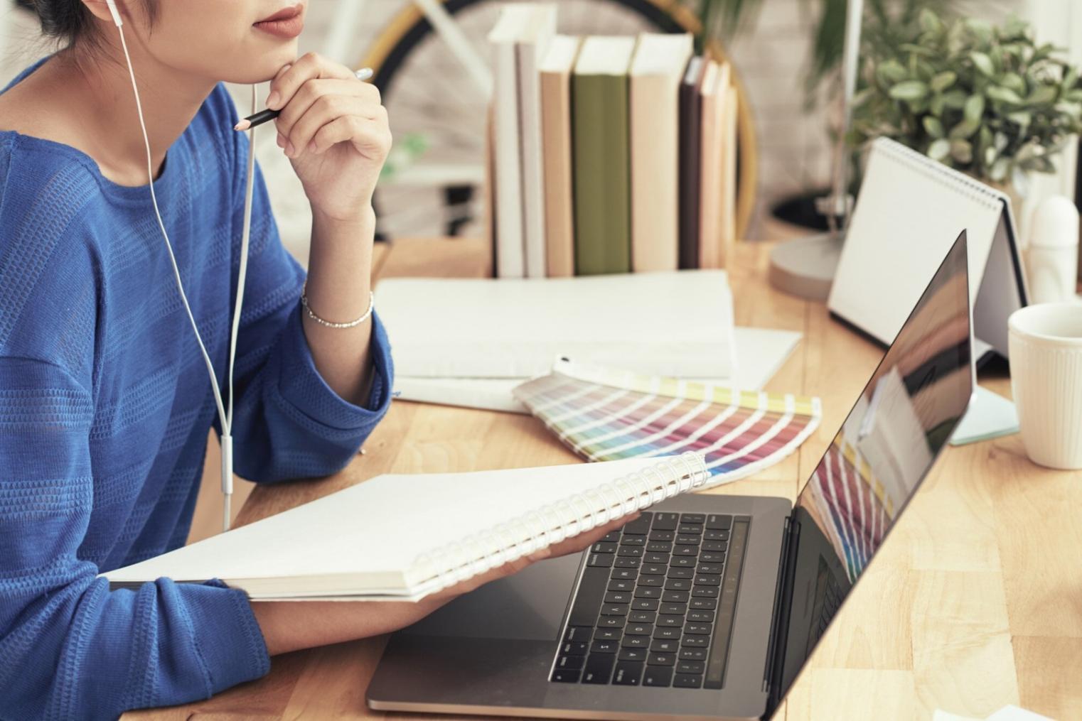 Students collaborating on financial planning projects with laptops and budgeting charts